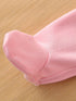 Close-up of a pink fabric item on a wooden surface