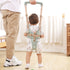 Child using a walking aid with a person assisting, in a home setting.