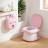 Pink children's potty seat with cartoon face design on a wooden floor.