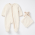 Cream fleece baby onesie with a full-length zipper and matching security blanket with a plush bear head.