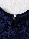 Close-up of a blue textured garment with a button on a white textured background
