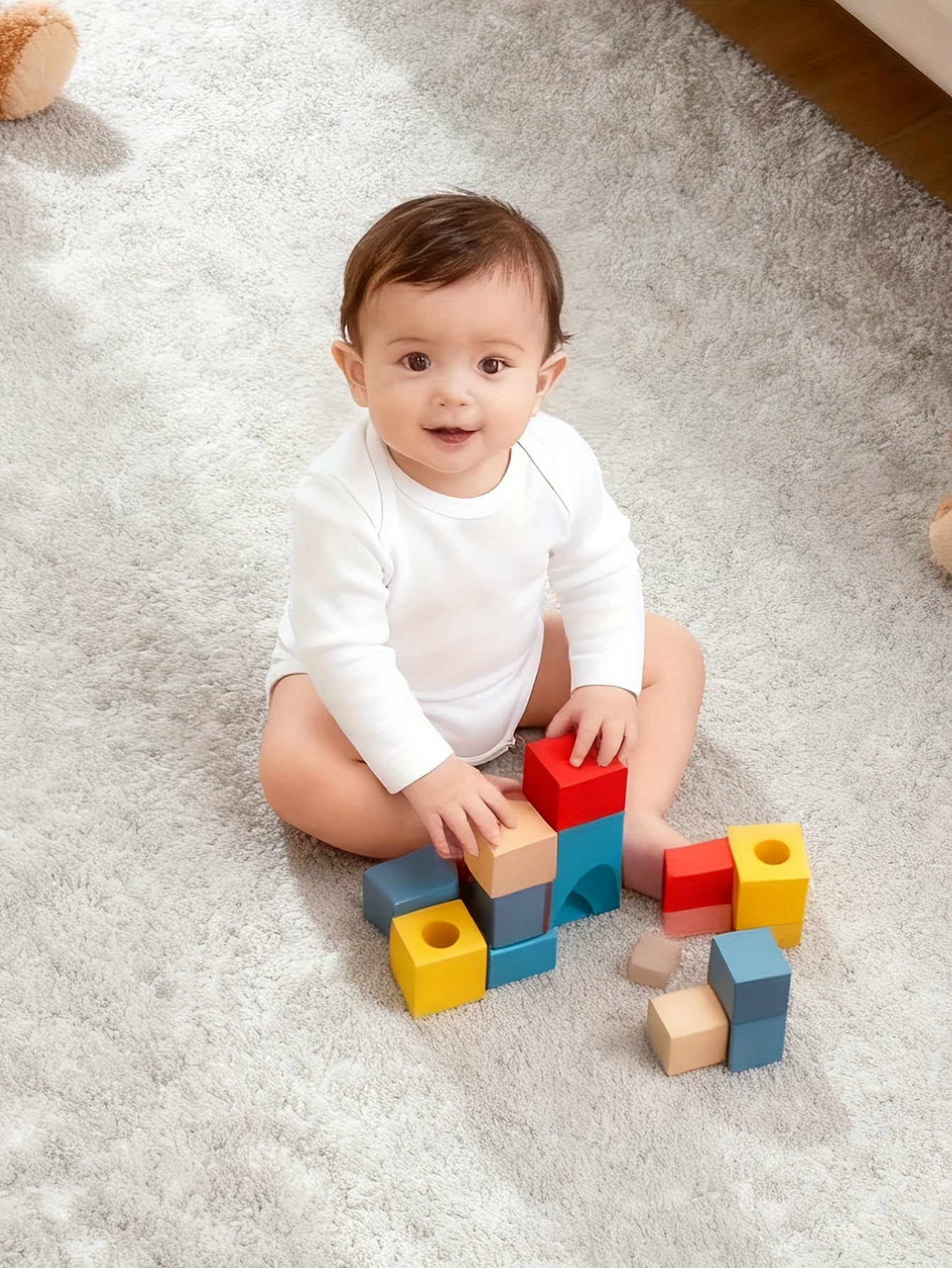 Baby playing with colorful blocks on a carpeted floor