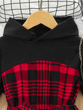 Black hoodie with red plaid pattern on a wooden hanger against a white background
