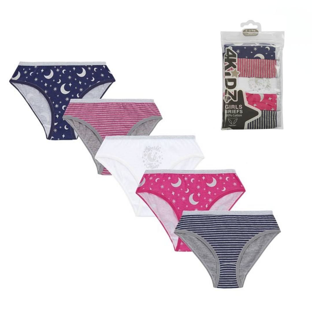 Four pairs of girls' briefs in assorted patterns and colors are displayed on a white background, alongside their retail packaging. The set includes navy blue with white moon and star prints, pink and gray stripes, solid white, and pink with white moon and star prints.