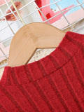 Red sweater on a wooden hanger with a blurred background
