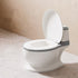White toilet with open lid in a bathroom setting