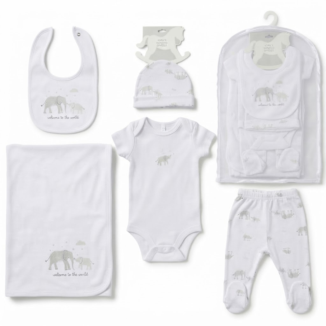 A white baby clothing gift set featuring a gray elephant print and the text 'welcome to the world', displayed with a matching bodysuit, pants, bib, cap, blanket, and packaging