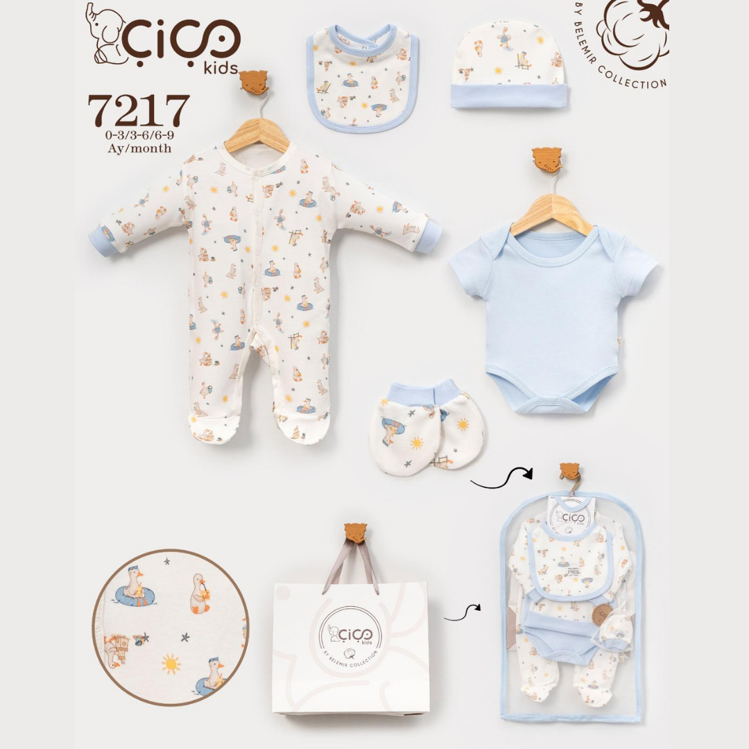 Baby clothing set from Cico Kids featuring a footless one-piece in cream with a light blue bunny print, a light blue short-sleeve bodysuit, matching bibs, a hat, and a pair of booties, displayed on wooden hangers alongside a gift bag and garment bag.