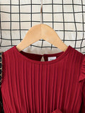Red dress on a wooden hanger against a grid background