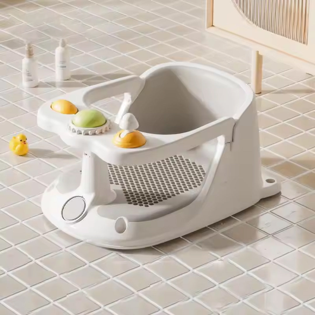 White baby bath seat with toys on a tiled bathroom floor