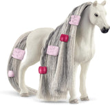Toy horse with braided mane and tail on a white background