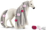 Toy horse with styled hair and accessories on a white background