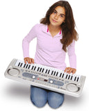 Young girl holding a large toy keyboard on a white background
