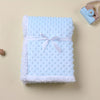 Light blue textured blanket with a white bow on a beige background