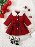 Red dress with white fur collar, red roses, sunglasses, and shoes on a white background
