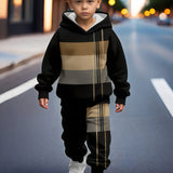 Child wearing a black and brown striped hoodie on a city street.
