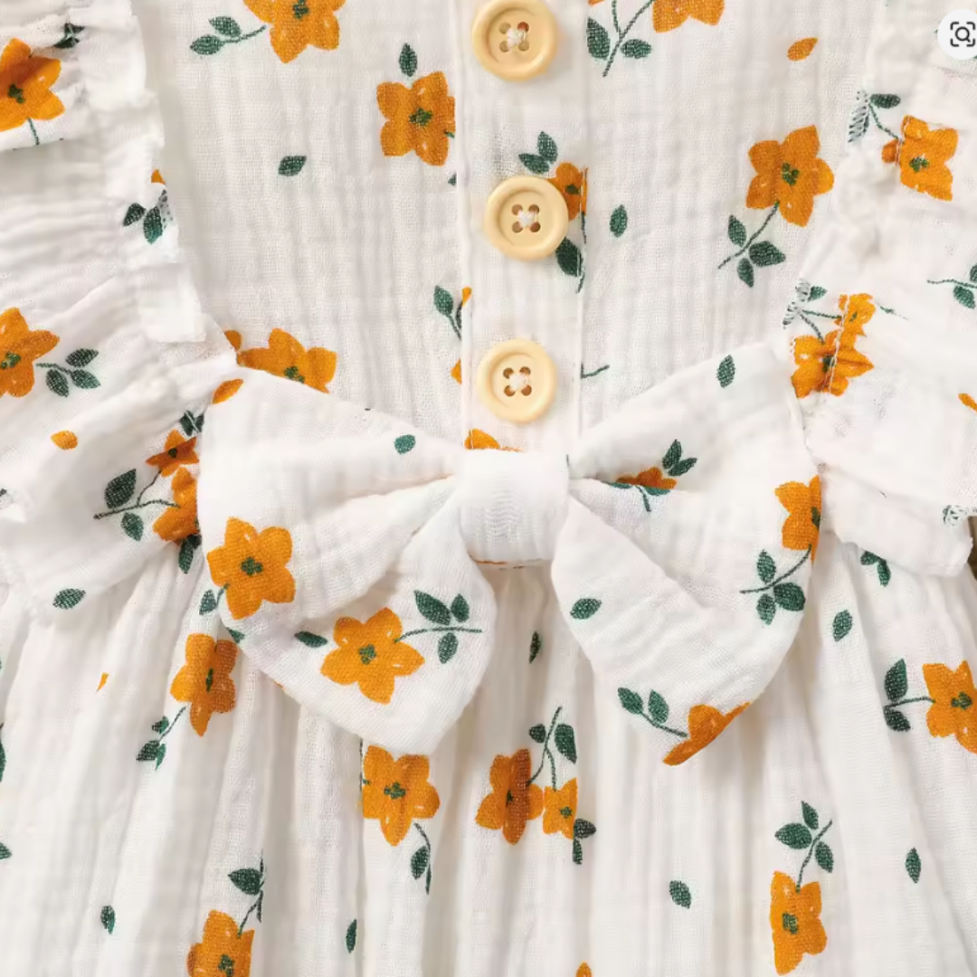 Floral-patterned fabric with a large white bow and buttons.