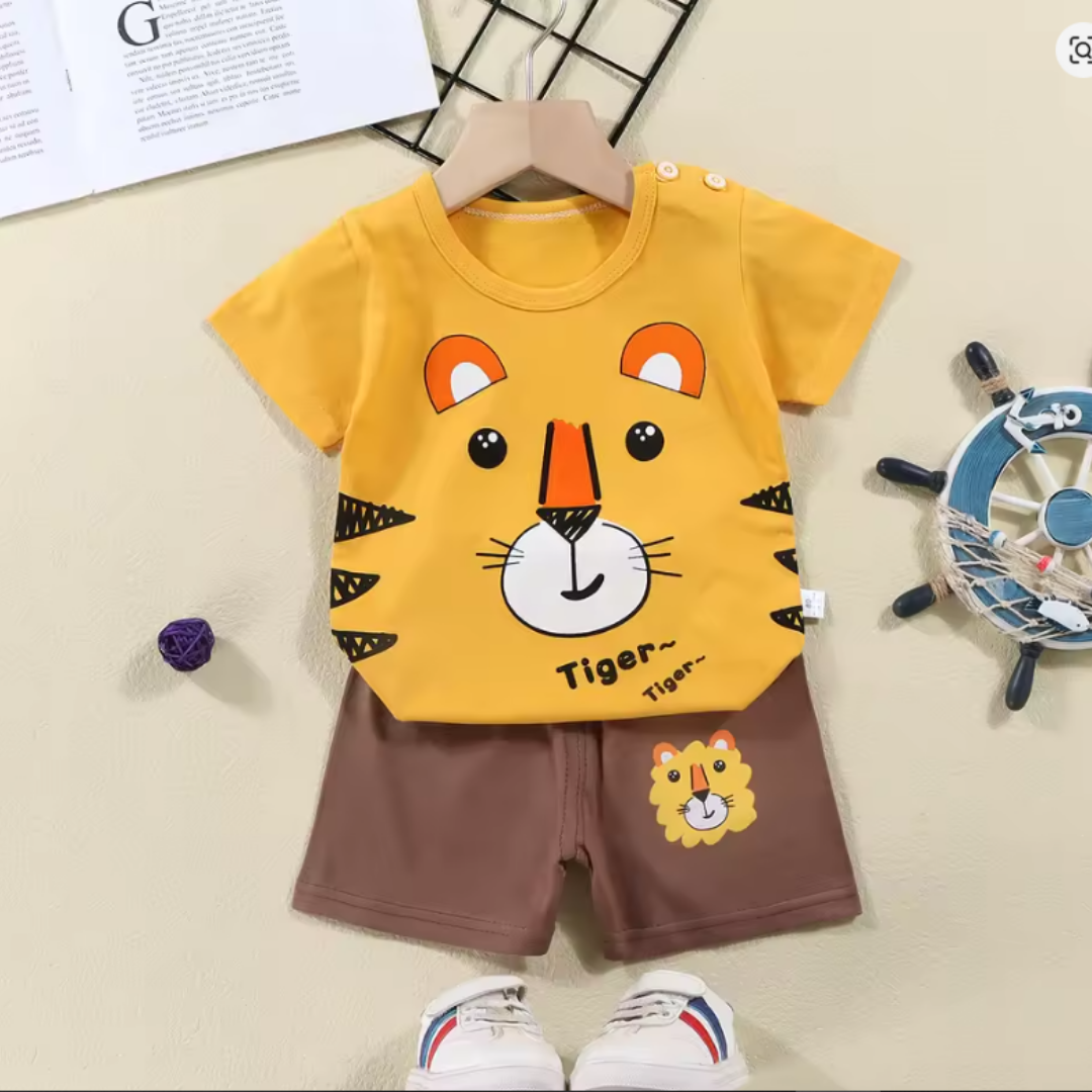 Children's outfit with a yellow t-shirt and brown shorts featuring tiger designs on a beige background.
