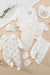 8-piece unisex newborn baby outfit set with Happy Little Bear print, including romper, jacket, pants, hat, bib and socks in neutral colors