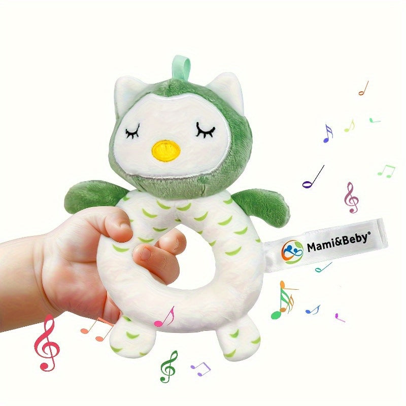 Green and white owl-shaped toy held by a hand with 'Mami&Baby' branding.