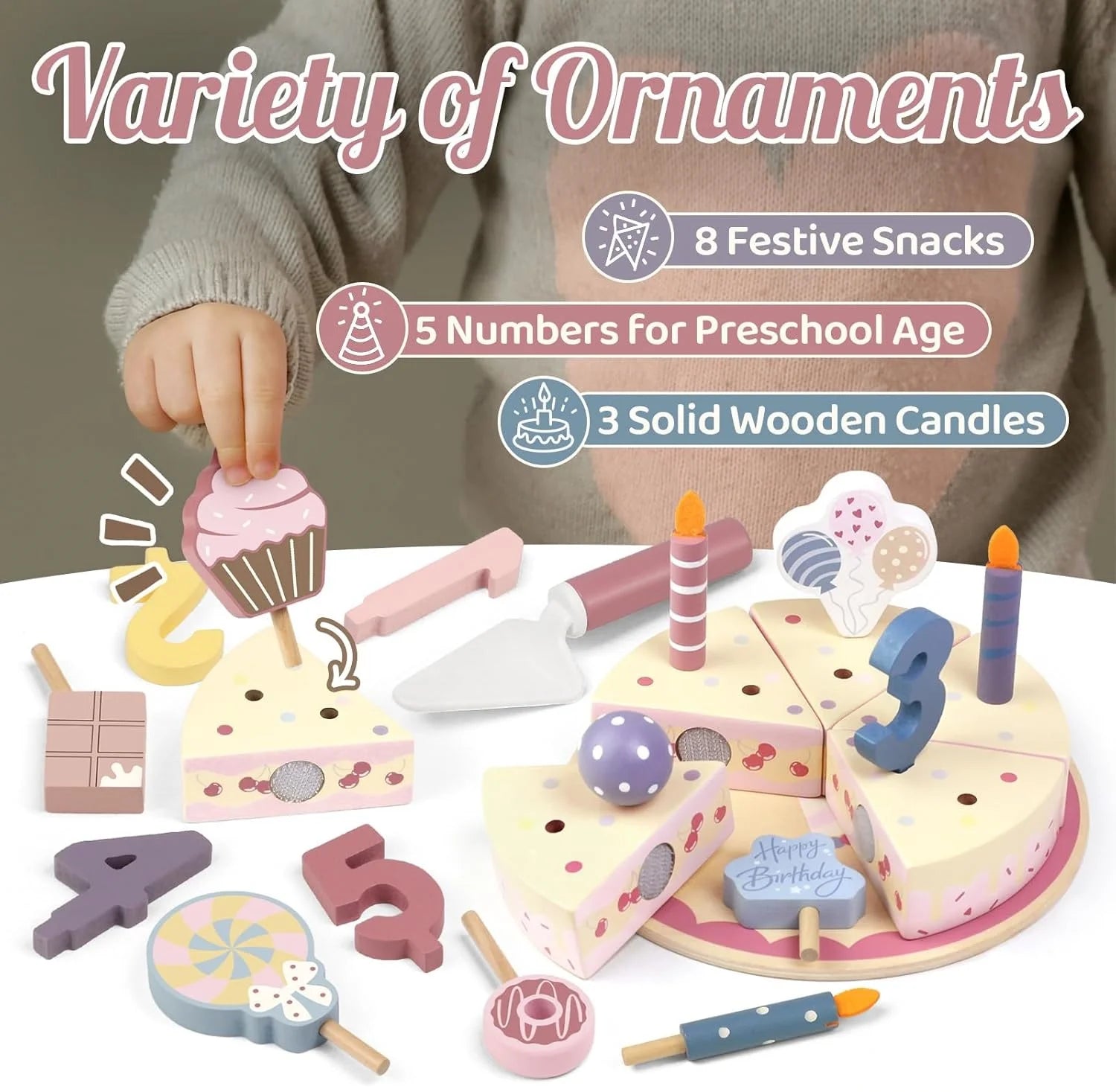 Wooden toy cake set with various accessories including numbers, candles, and snacks on a white surface.