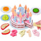 Toy birthday cake with candles and number blocks on a white background