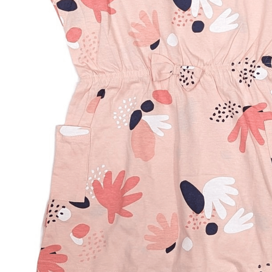 Close-up of a pink dress with abstract floral pattern on a white background
