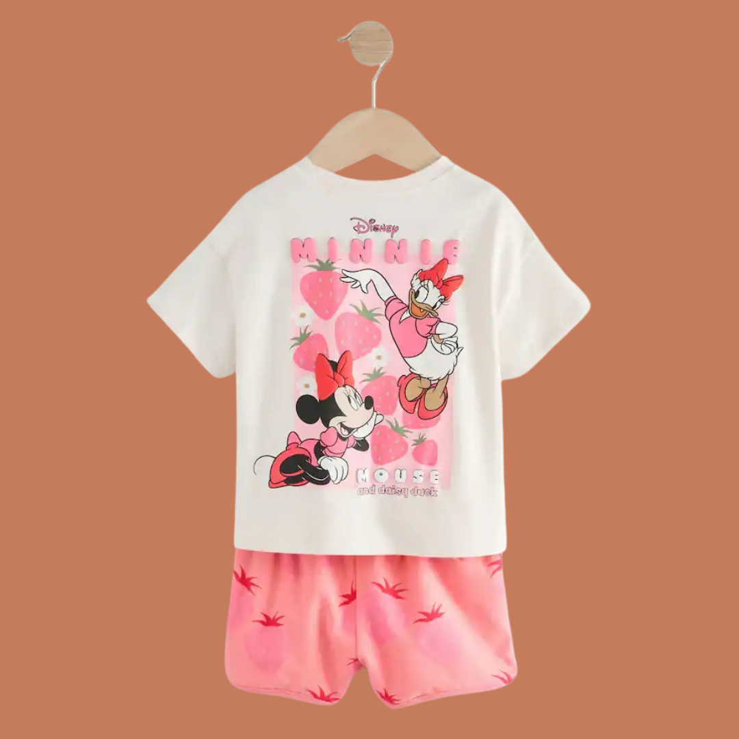 Children's outfit with a white t-shirt and pink shorts featuring Disney characters on a brown background.