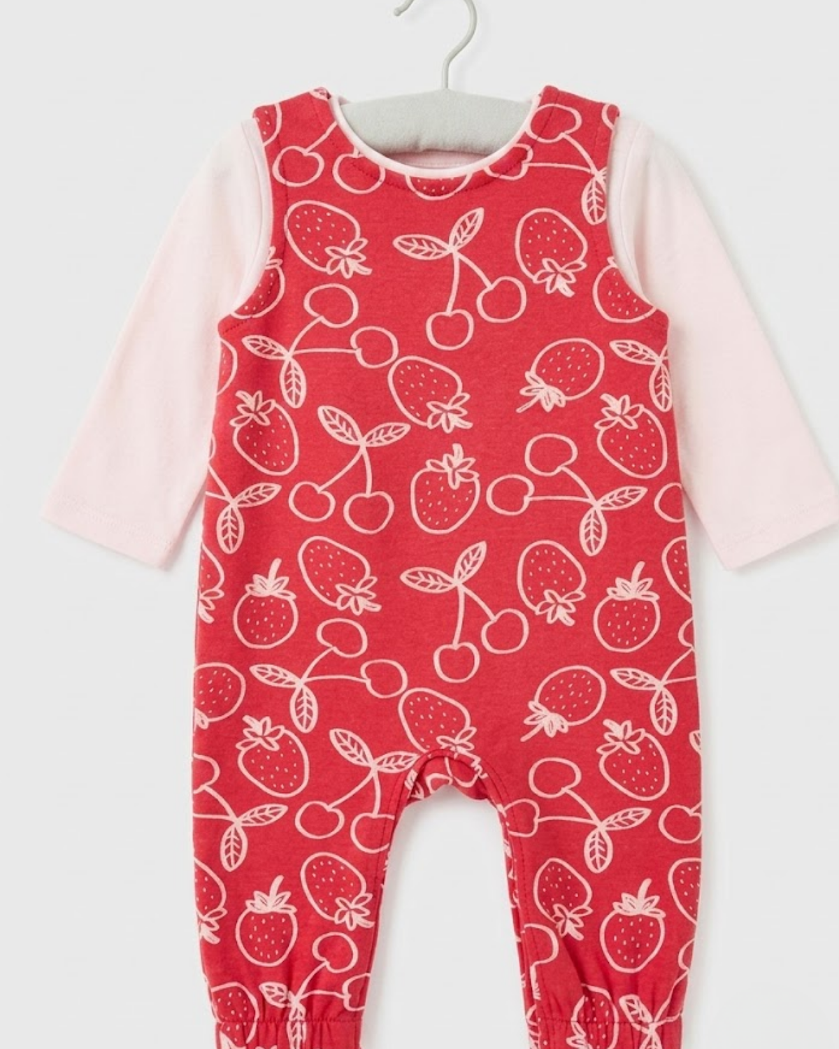 Red romper with fruit pattern on a white background