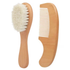 Wooden brush with bristles and wooden comb on a white background