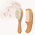 Wooden baby brush and comb set on a white background
