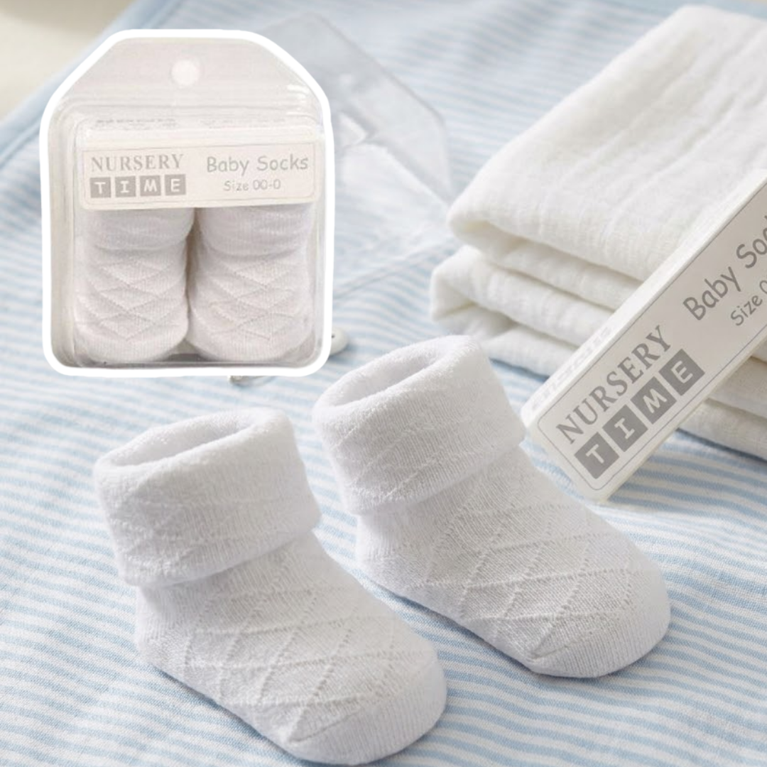 White baby socks with packaging on a striped background