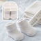 White baby socks with packaging on a striped background