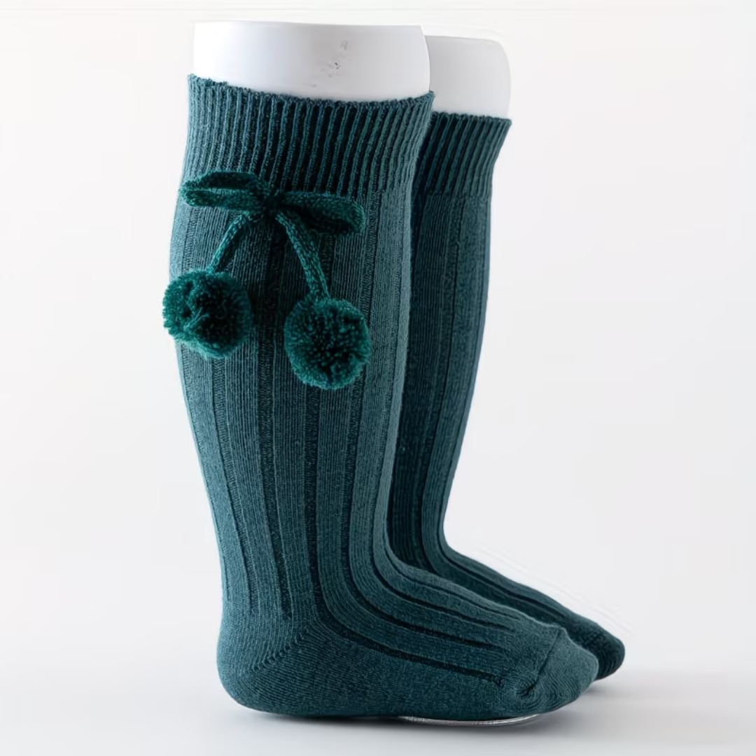 Teal knee-high socks with pom-poms on a white background