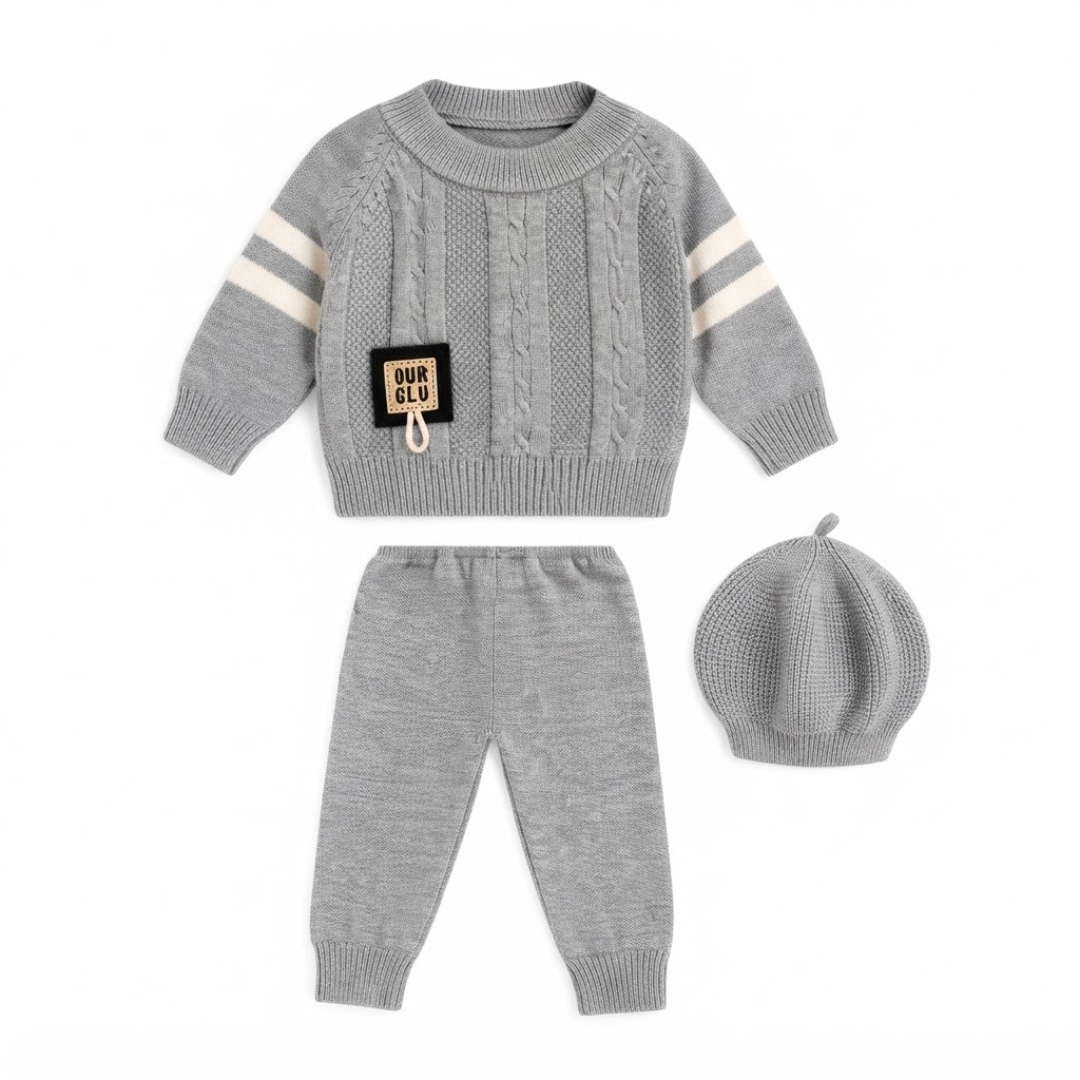 Grey baby cable-knit sweater, trousers, and beret outfit set displayed flat on a clean white background.