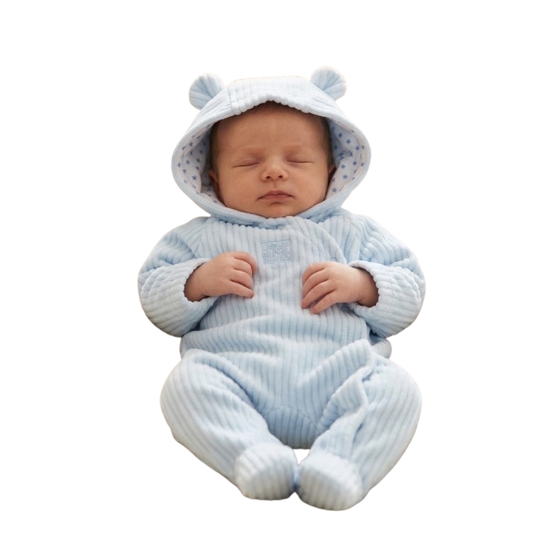 Sleeping baby wearing a light blue hooded pram suit with bear ears.