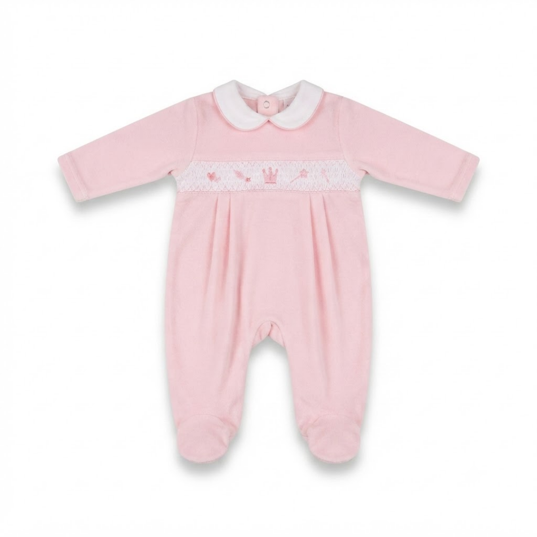 A light pink baby footed romper with long sleeves, a white Peter Pan collar, and a smocked chest panel featuring a small embroidered crown.