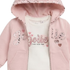 A baby girl's pink zip-up hoodie with a white graphic t-shirt underneath. The hoodie features 'Jolie' and 'lie' spelled out in sparkling silver and pink sequins, accented with small pink hearts.