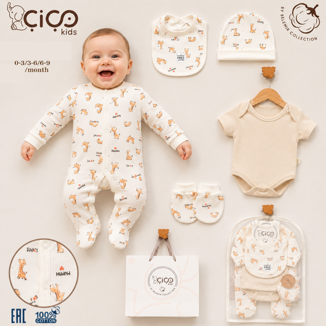 A baby outfit set displayed on a light beige background with a smiling baby lying on top. The set includes a cream-colored footless one-piece with a small orange animal print, a matching bib, a beanie, a short-sleeve bodysuit, and booties.