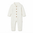 A baby footed sleeper set laid flat on a cream fabric background, including a navy blue and white long-sleeve sleeper with embroidered car details on the chest, and a matching navy blue and white beanie hat.