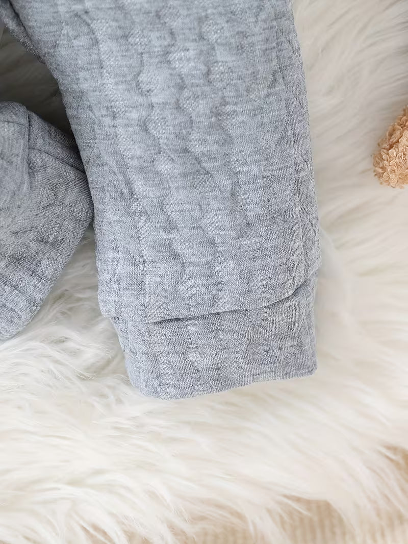 Gray textured fabric on a fluffy white surface