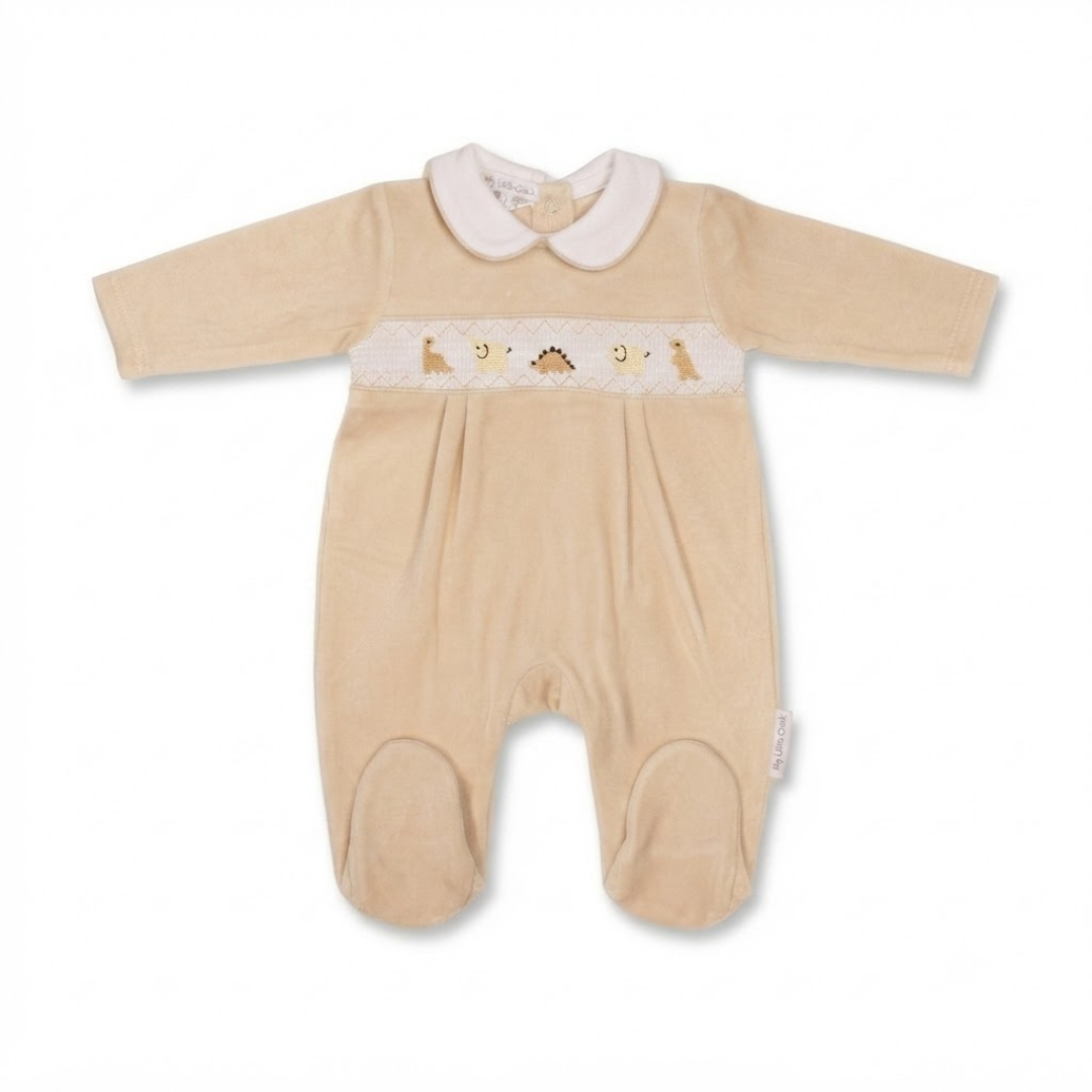 A baby footed sleeper in beige corduroy with a white Peter Pan collar and a decorative embroidered chest band featuring small animals.