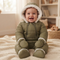 A baby wear Warm Plush Snowsuit sitting on the bed