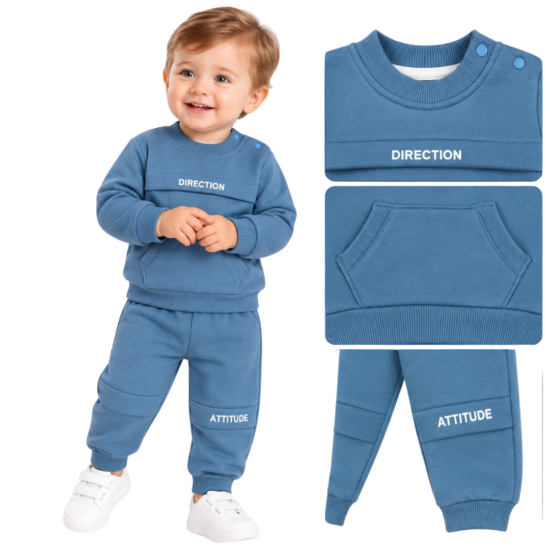 A toddler wearing a blue sweatshirt and matching jogger pants set with white sneakers, shown beside close-up detail panels of the outfit. The sweatshirt and pants are blue with white text reading 'DIRECTION' and 'ATTITUDE' respectively, on a plain white background.