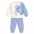 A baby two-piece waffle knit outfit set featuring a long-sleeve top and matching pants. The top is cream-colored on one side and light blue on the other, with a large blue bear face graphic and the word 'Hello' on the chest.