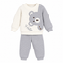 A baby two-piece waffle knit pajama set featuring a long-sleeve top with an off-white and gray color-blocked design, a gray bear face applique on the chest, and the word 'Hello' embroidered below, paired with matching gray ribbed pants.