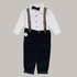 Children's outfit with white shirt, black suspenders, and black pants on a beige background