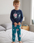 Boy wearing a navy blue long-sleeve top and teal pants with space-themed designs