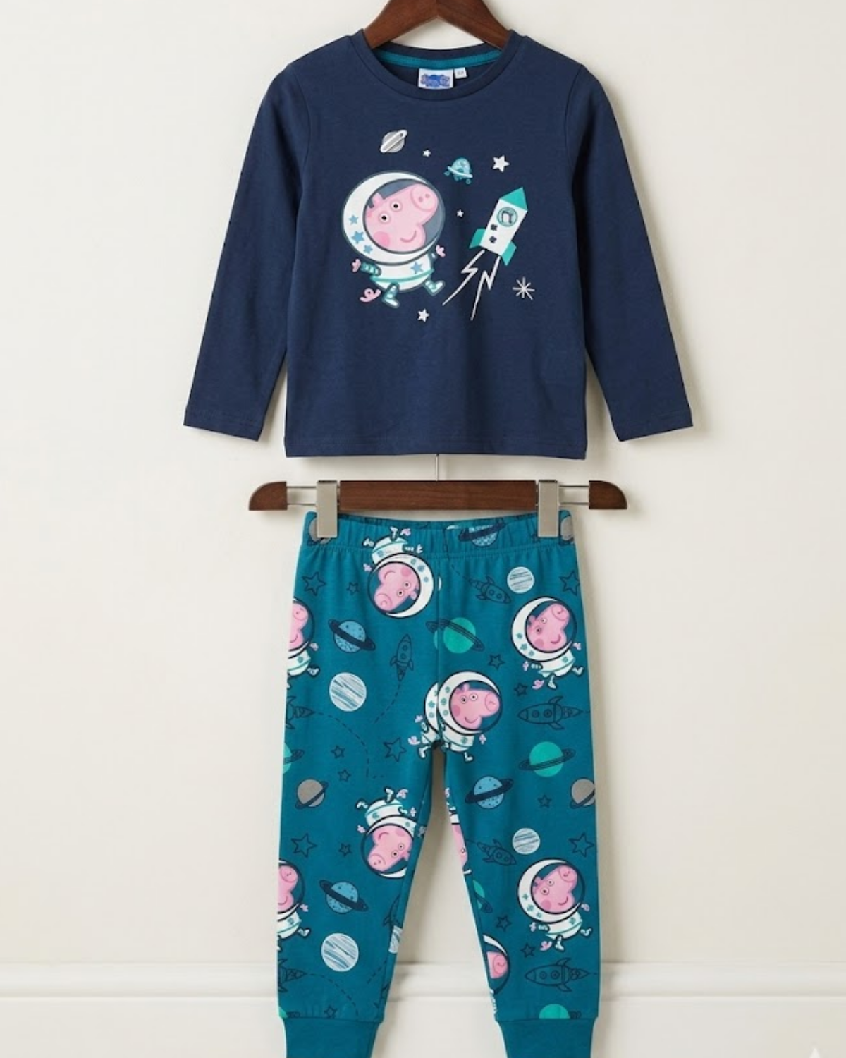 Children's pajama set with space-themed design on a white background