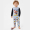 Child wearing Paw Patrol pajamas on a white background